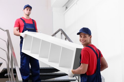 Commercial moving team preparing items for relocation in Nottinghill storage facility